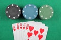 Casino chips and cards with a winning combination of royal flush on the table Royalty Free Stock Photo