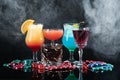 Casino chips, dice and alcohol drinks on dark background with smoke Royalty Free Stock Photo