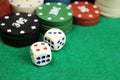 Casino chips and dice on a green felt table, selective focus Royalty Free Stock Photo