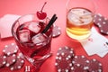 Casino chips, dice, playing cards and alcohol drinks on red table, closeup Royalty Free Stock Photo