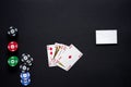 Casino chips, playing cards and business card on black background. Royal flash