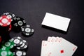 Casino chips, playing cards and business card on black background. Royal flash