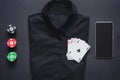 Casino chips, playing cards on formal shirt and mobile phone. set of four aces