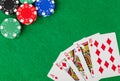 Casino chips and playing cards on green table Royalty Free Stock Photo