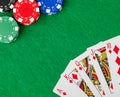 Casino chips and playing cards on green table Royalty Free Stock Photo