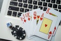 casino chips and playing cards on laptop notebook. Poker game online concept Royalty Free Stock Photo