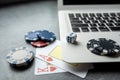 casino chips and playing cards on laptop notebook. Poker game online concept Royalty Free Stock Photo