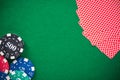 Casino chips and poker cards on green felt, background Royalty Free Stock Photo