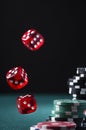 Casino Chips Stack and Flying Dices on Green Poker Table Royalty Free Stock Photo