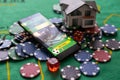 Casino chips with toy house - housing market gamble concept.