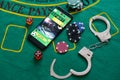 Casino chips a winning combination of cards flush royal next to the police handcuffs Royalty Free Stock Photo