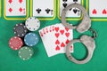 Casino chips a winning combination of cards flush royal next to the police handcuffs Royalty Free Stock Photo