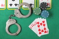 Casino chips a winning combination of cards flush royal next to the police handcuffs Royalty Free Stock Photo