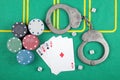 Casino chips winning combination of cards four aces next to police handcuffs Royalty Free Stock Photo