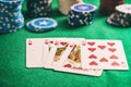 Casino, gambling concept. Hearts royal flush cards and poker chips on green felt Royalty Free Stock Photo