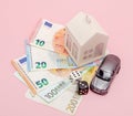 Casino, gambling and fortune concept. Model house and car, games dice and euro money on pink background with copy space Royalty Free Stock Photo