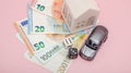 Casino, gambling and fortune concept. Model house and car, games dice and euro money on pink background with copy space Royalty Free Stock Photo