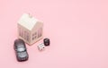 Casino, gambling and fortune concept. Model house and car, games dice on pink background with copy space Royalty Free Stock Photo