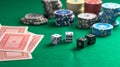 Casino, gambling. Poker chips piles, playing cards and dice on green felt background Royalty Free Stock Photo