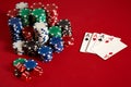 Casino gambling poker equipment and entertainment concept - close up of playing cards and chips at red background. Four Royalty Free Stock Photo