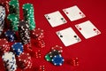 Casino gambling poker equipment and entertainment concept - close up of playing cards and chips at red background. Four Royalty Free Stock Photo