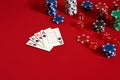 Casino gambling poker equipment and entertainment concept - close up of playing cards and chips at red background. Four Royalty Free Stock Photo