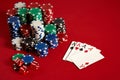 Casino gambling poker equipment and entertainment concept - close up of playing cards and chips at red background. Four Royalty Free Stock Photo