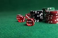 Poker chips and red dice on green table Royalty Free Stock Photo