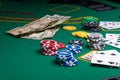 Casino, night life, online gambling business games. Chips, cards and dollars on a green table