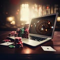 casino online. laptop with roulette chips and playing cards.