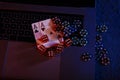 Casino play online concept. Playing chips, cards and dices on laptop