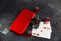 Casino play online concept. Playing chips, cards, red dices and smartphone
