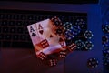 Casino play online. Playing chips, cards and dices on laptop's keyboard. Top view