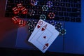 Casino play online. Playing chips, cards and dices on laptop. Top view