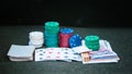 Casino poker chips stack with playing cards, dice and money on green felt background Royalty Free Stock Photo