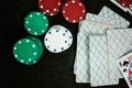 Casino poker chips stack with playing cards, dice and money on green felt background Royalty Free Stock Photo