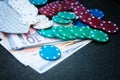 Casino poker chips stack with playing cards, dice and money on green felt background Royalty Free Stock Photo