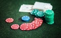 Casino poker chips stack with playing cards, dice and money on green felt background Royalty Free Stock Photo