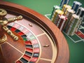 Casino roulette wheel with casino chips on green table. Gambling Royalty Free Stock Photo