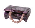 Casket from charoit with a beads from quartz Royalty Free Stock Photo