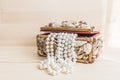 Casket with pearl beads on wood table