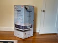 Casper home mattress delivery box inside home next to door. Weathered and damaged from shipping and freight