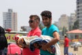 Caspian Sea, Iran - May 25, 2017: two Iranian young fathers men hold their babies babies in their arms while their wives are