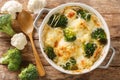 Casserole Cauliflower and broccoli baked with cheese sauce in a pot close-up. horizontal top view