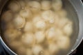 Saucepan with dumplings in hot water coming to a boil a second before filling the stomach semi-finished