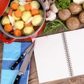 Casserole with organic vegetables and cookbook Royalty Free Stock Photo