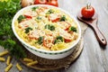 Casserole with pasta, broccoli and tomatoes