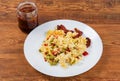 Casserole with pasta on dish, sun-dried tomatoes in jar Royalty Free Stock Photo