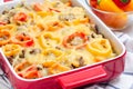 Casserole with potatoes, sausage and colorful bell pepper, in baking dish, horizontal, closeup Royalty Free Stock Photo