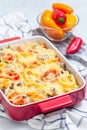 Casserole with potatoes, sausage and colorful bell pepper, in baking dish, vertical Royalty Free Stock Photo